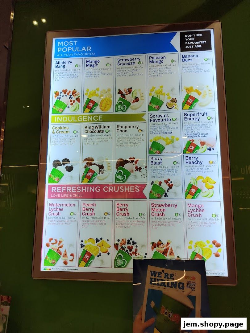 A digital menu board displaying various Boost Juice drinks with images and prices.