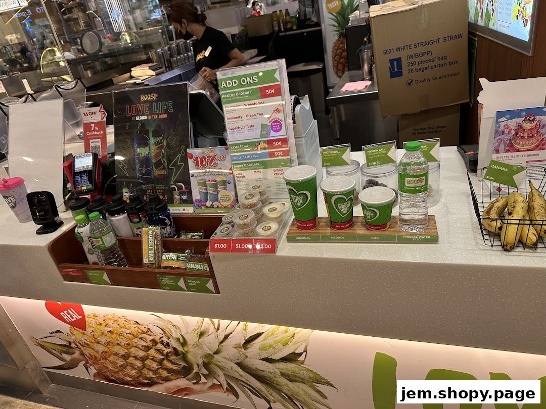 A Boost Juice counter displaying various drinks, snacks, and promotional materials.