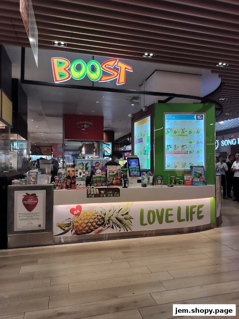 The Boost Juice shop front with vibrant branding, fruit imagery, and a menu display.