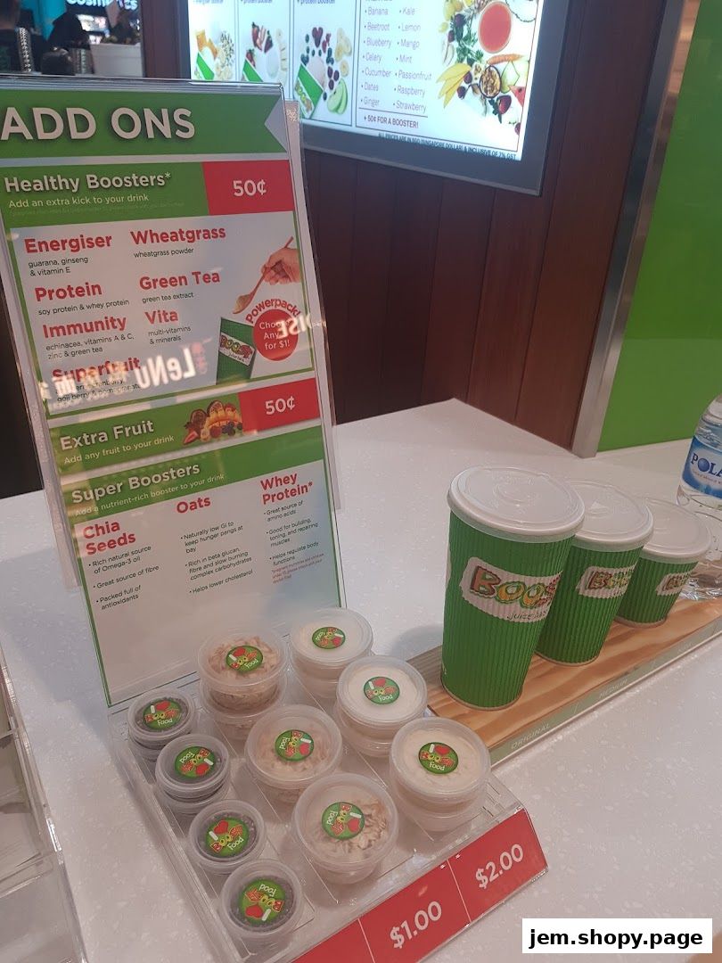A menu board displaying Boost Juice add-ons, boosters, and extra fruit options.