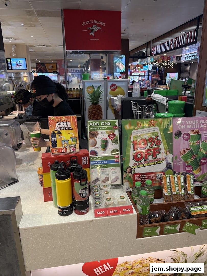 A Boost Juice counter with promotional materials, drinks, and snacks displayed.