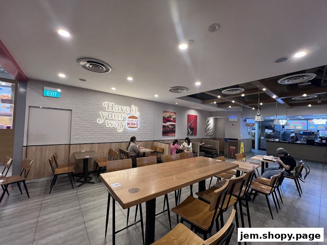 Interior view of a Burger King restaurant with seating areas and a counter.