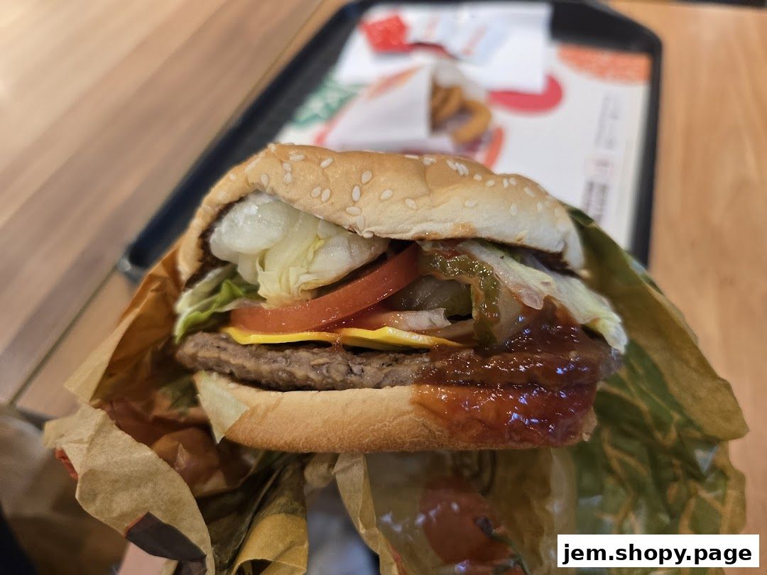 A close-up shot of a juicy Burger King burger with fresh toppings and sauce.