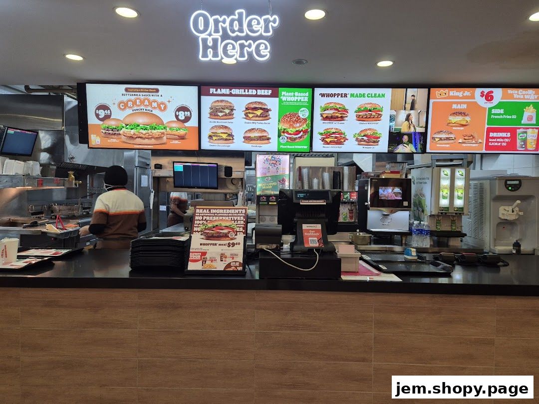 Burger King counter with digital menu boards displaying burgers and meal deals.