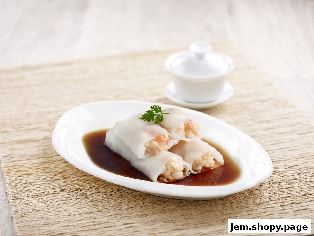 A plate of three shrimp rice noodle rolls served in a savory sauce.