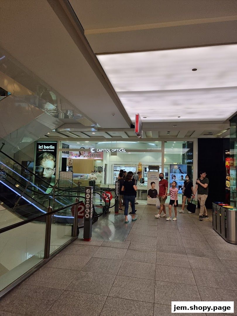 Capitol Optical shop front with displays of glasses and people browsing.
