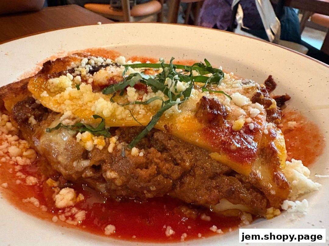 A close-up shot of a delicious-looking lasagna dish topped with cheese and herbs.