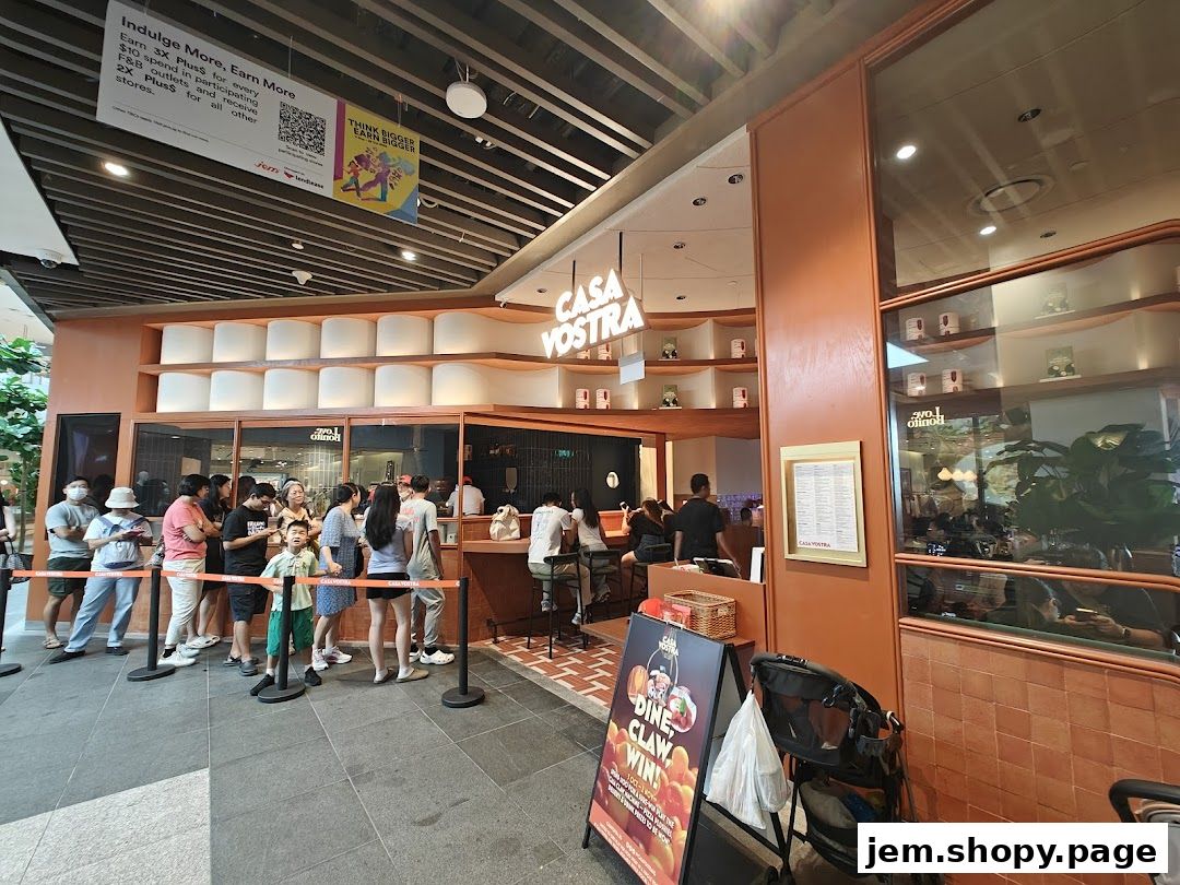 A busy Casa Vostra restaurant with a queue of customers and a promotional sign.