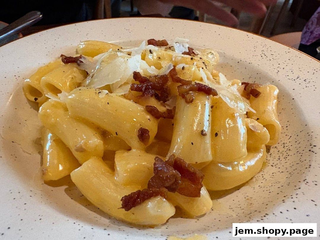A close-up shot of a delicious pasta dish with bacon and cheese.