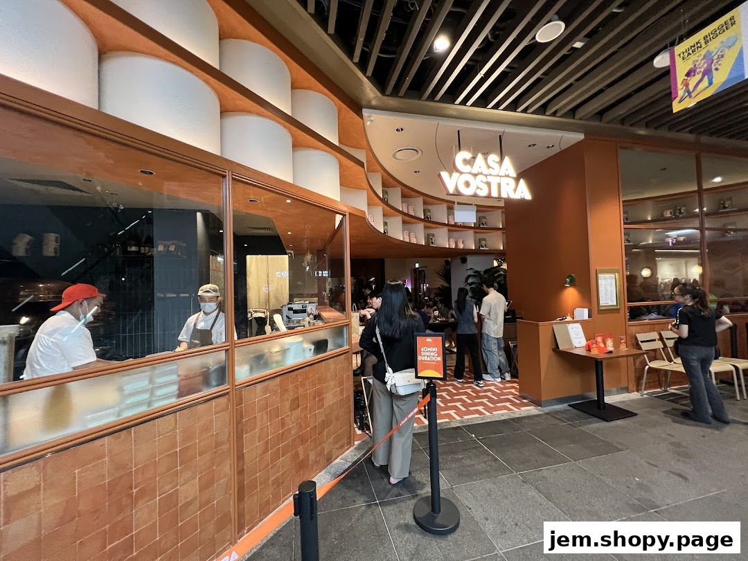 The entrance of Casa Vostra restaurant with staff visible behind a counter.