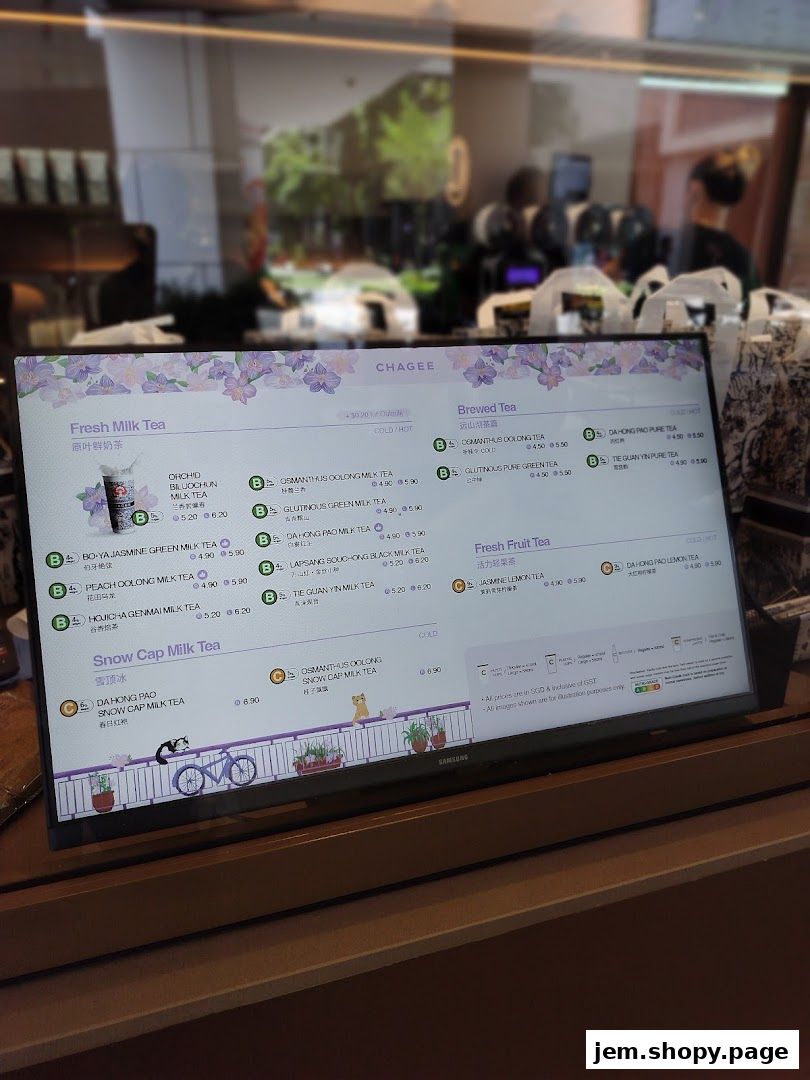 A digital menu board displaying various milk teas, brewed teas, and fruit teas with prices.
