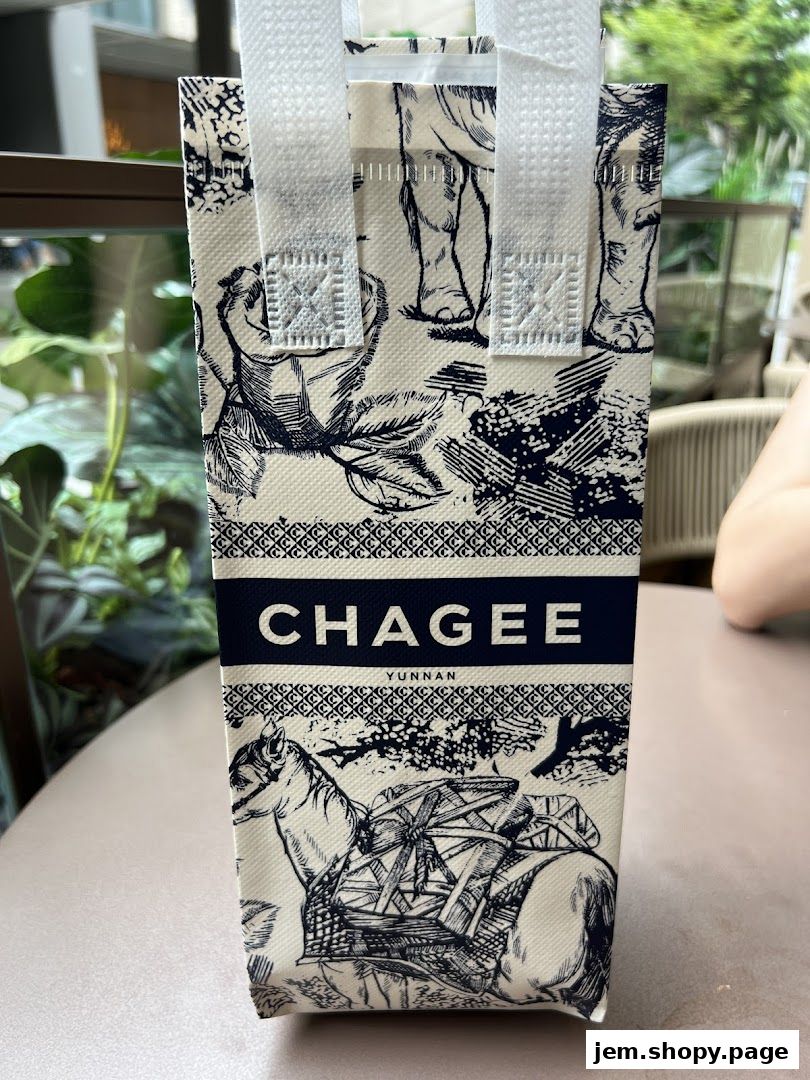 A CHAGEE branded tote bag with intricate blue and white designs.
