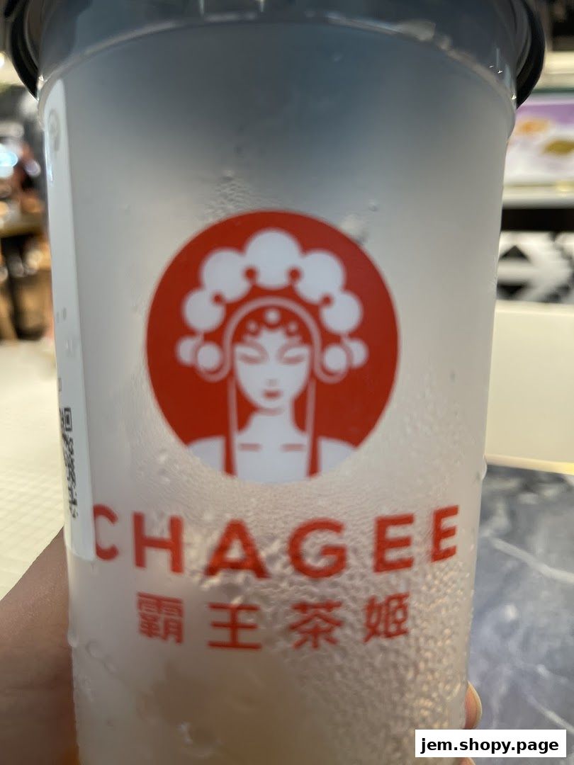 A close-up of a CHAGEE branded beverage cup with condensation.