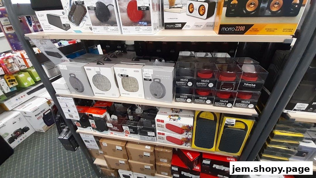 Shelves stocked with various portable speakers and audio accessories from Challenger JEM.