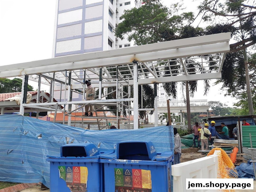 Construction workers are building a new structure with scaffolding and blue tarps.