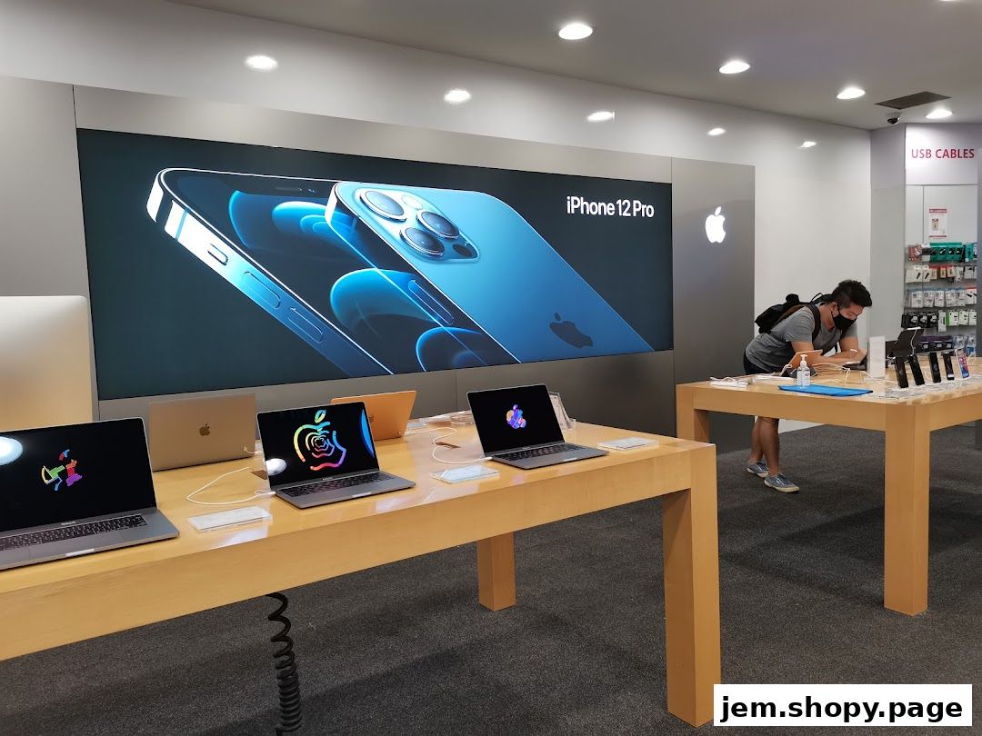 Inside an Apple store, showcasing MacBooks and an iPhone 12 Pro advertisement.