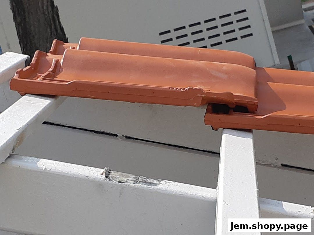 Close-up of terracotta roof tiles on a white structure.