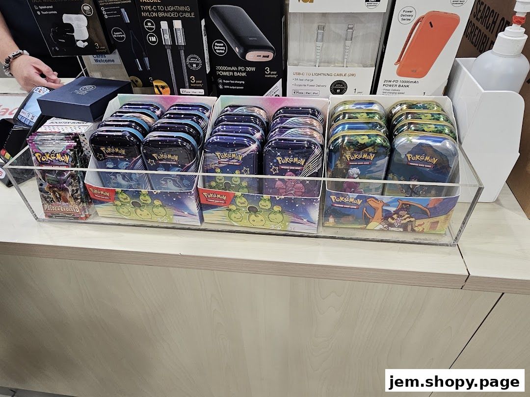 Display of Pokemon trading card game tins and booster packs at Challenger JEM.