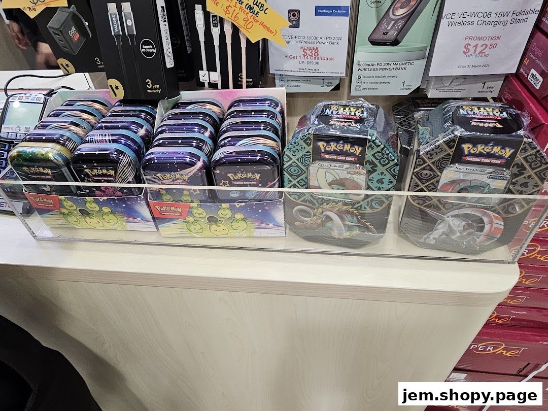 Display of Pokemon trading card tins and other electronic accessories at Challenger JEM.