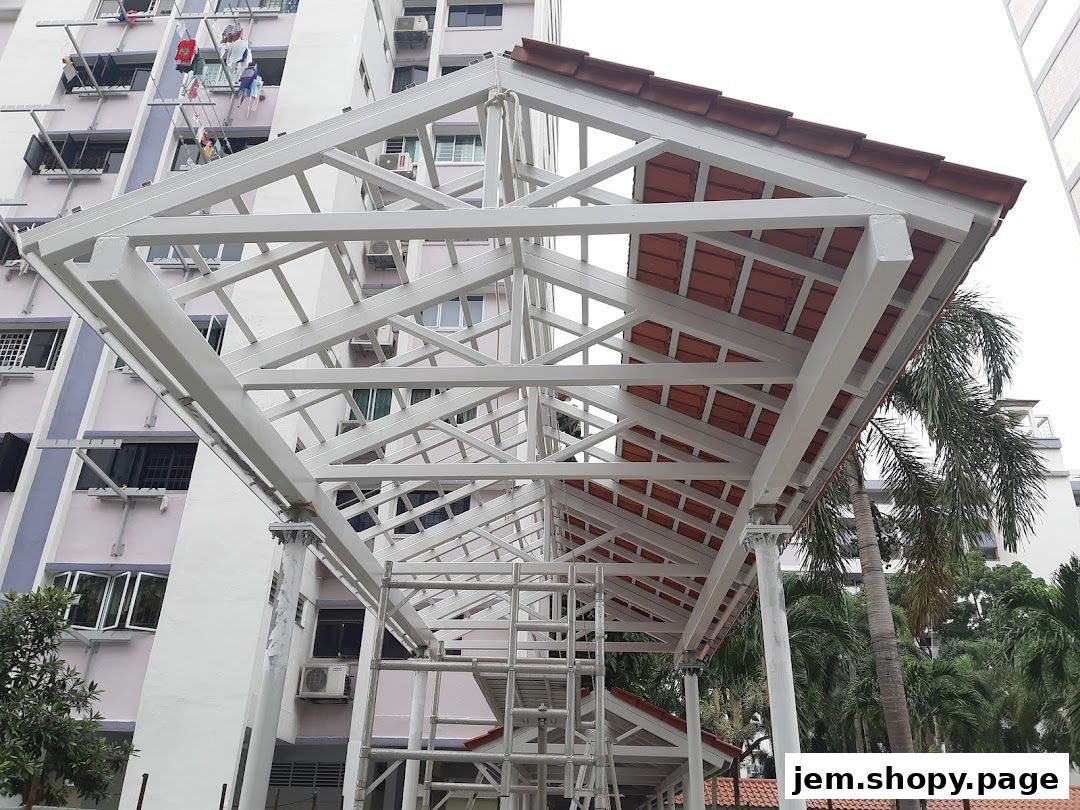 A white metal canopy structure with terracotta tiles, set against apartment buildings.