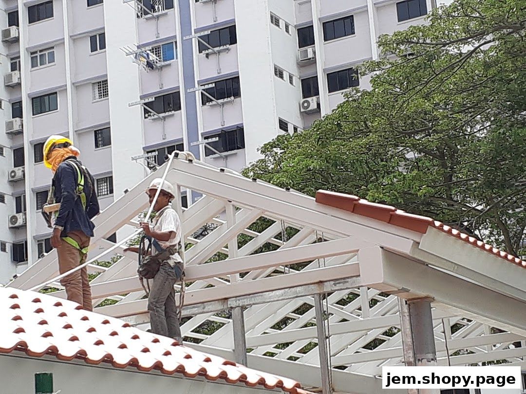 Construction workers installing a roof structure with a building in the background.