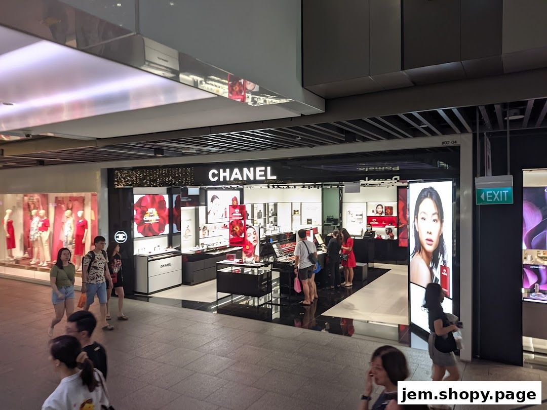 Chanel store entrance with makeup displays and promotional images.