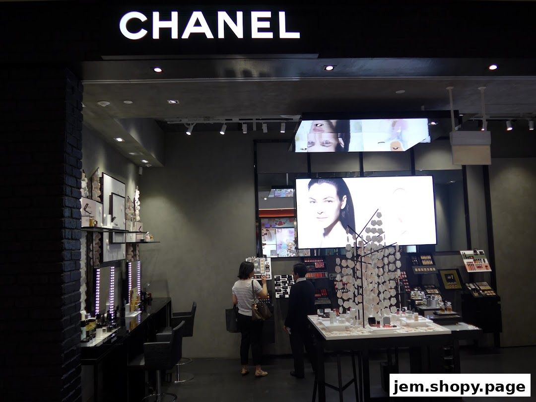 Interior of a Chanel store showcasing makeup and beauty products with digital displays.