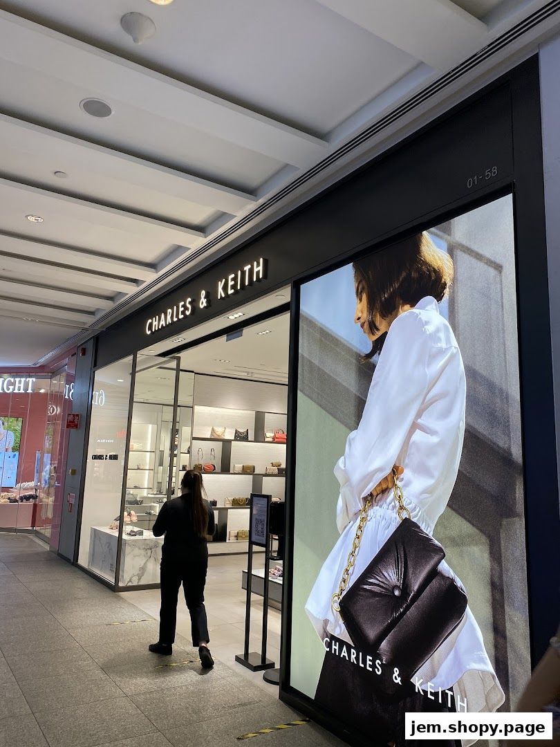 The exterior of a Charles & Keith store with a large advertisement featuring a handbag.