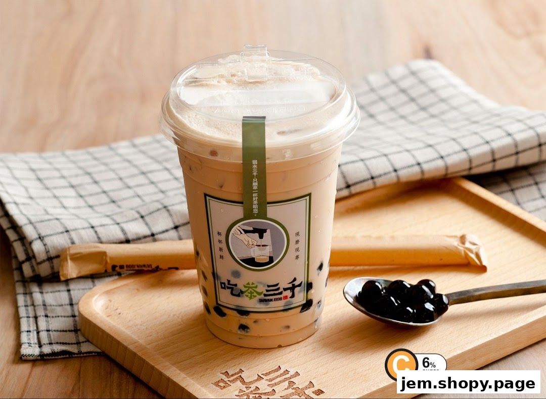 A cup of bubble tea with tapioca pearls on a wooden tray with a spoon.