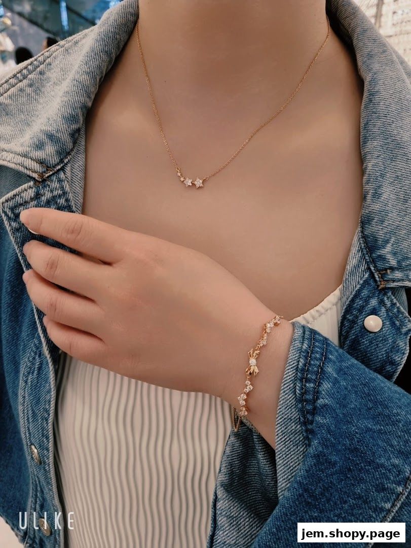 A person wearing a delicate star-themed necklace and bracelet from Chomel.
