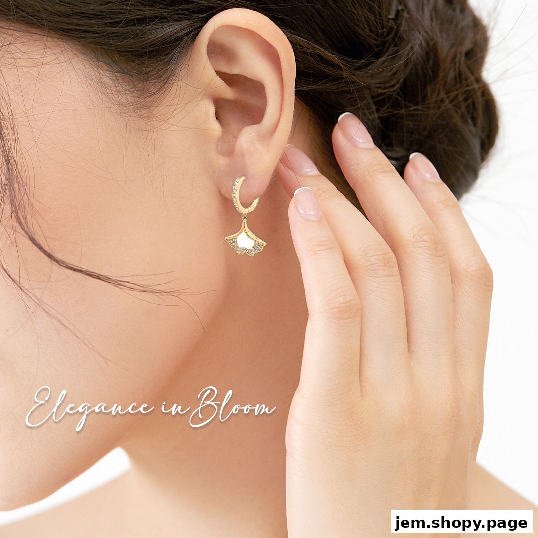 Close-up of a woman's ear wearing a delicate ginkgo leaf-shaped earring.