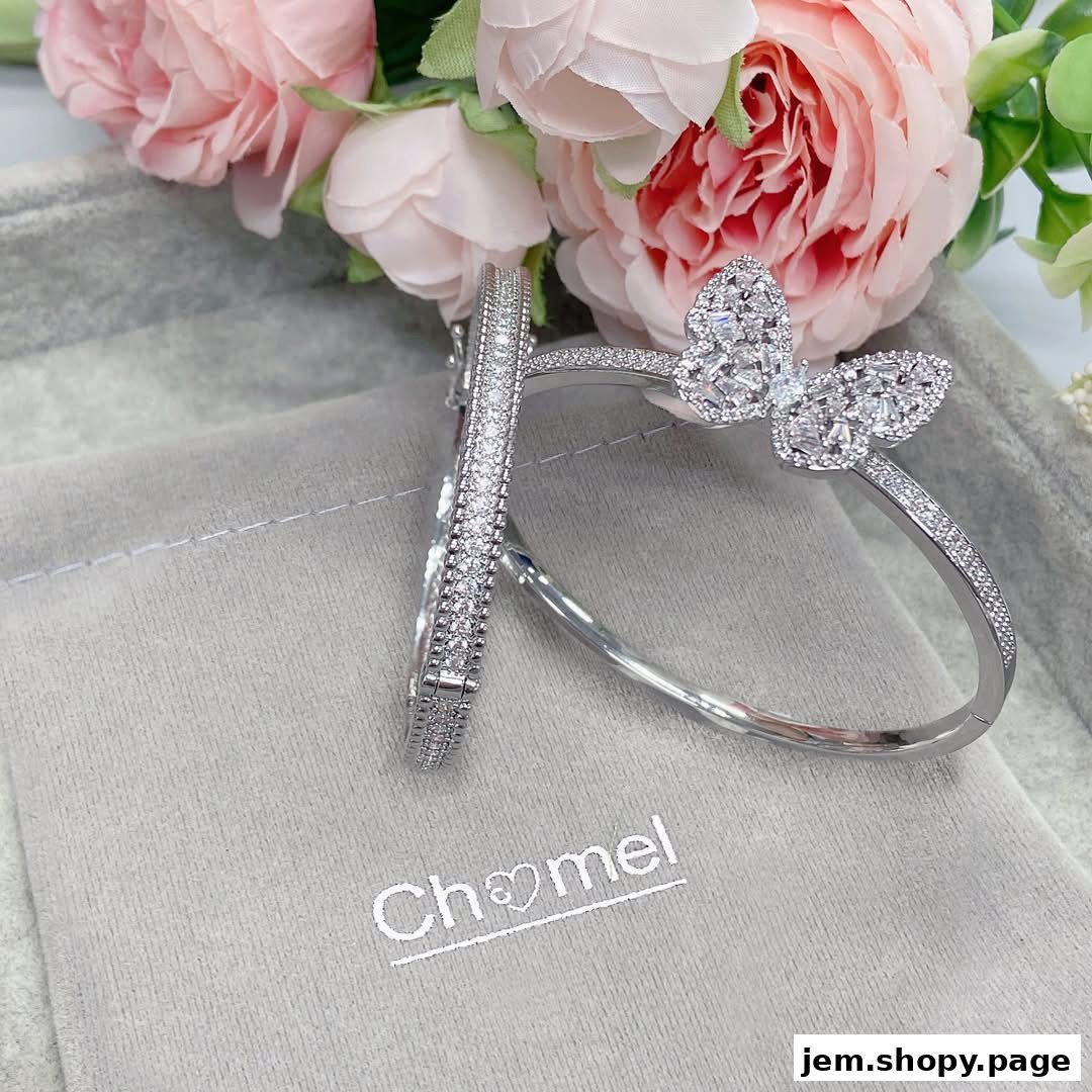 Sparkling diamond-encrusted butterfly and bangle bracelets displayed with pink flowers.