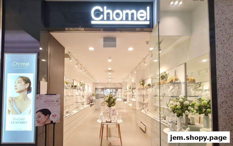 The entrance of Chomel, a jewelry store, showcasing its elegant displays and promotions.