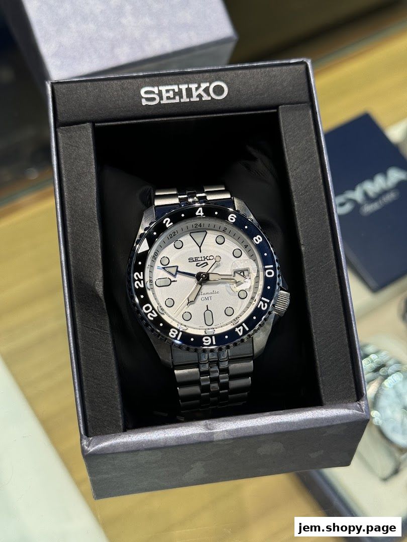 A Seiko automatic GMT watch displayed in its original packaging.