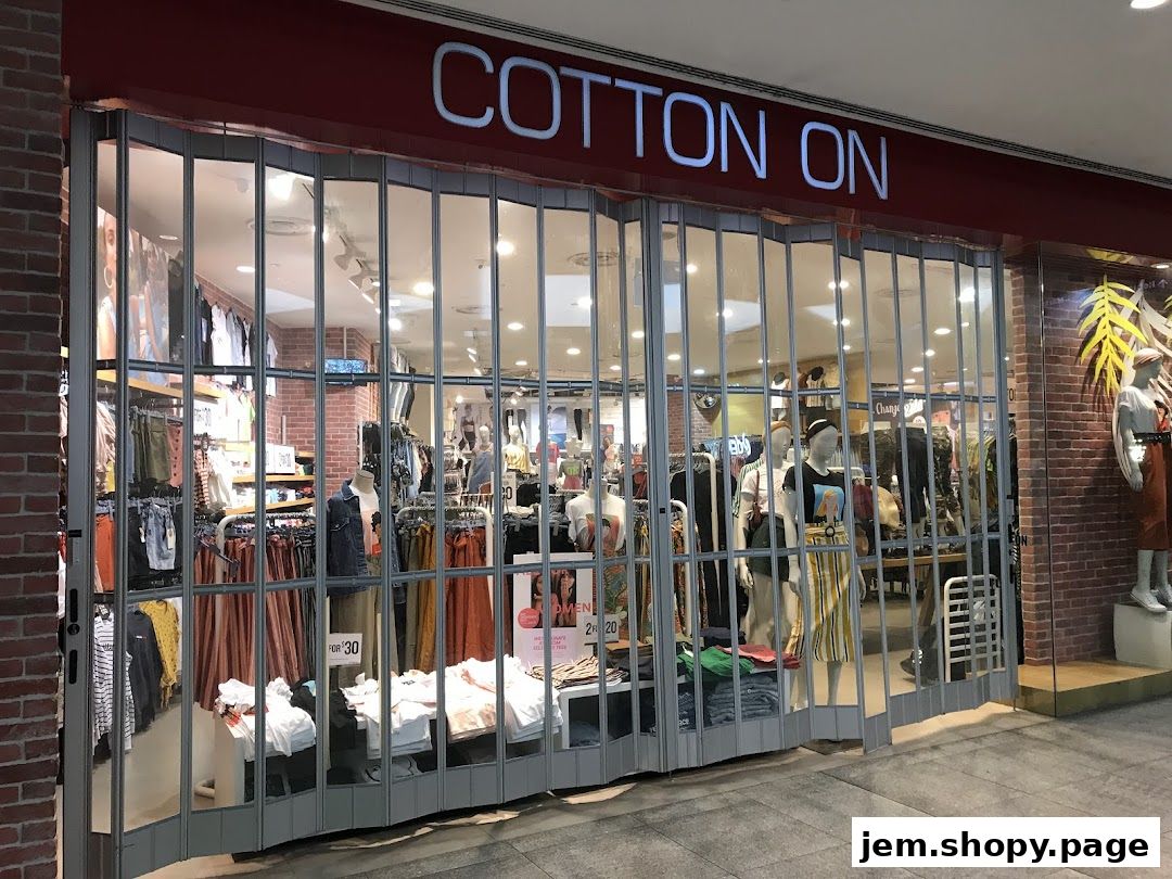 The Cotton On shop entrance with closed security shutters displaying clothing and mannequins.