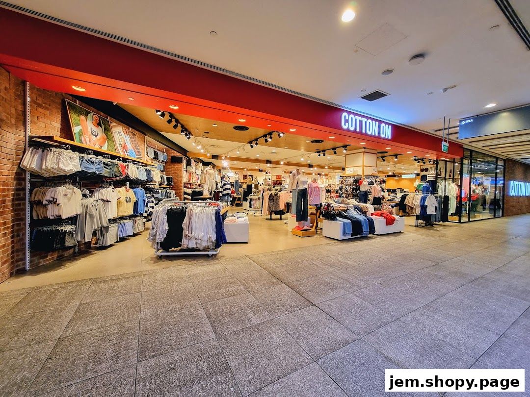 The exterior of a Cotton On clothing store displaying various apparel and mannequins.