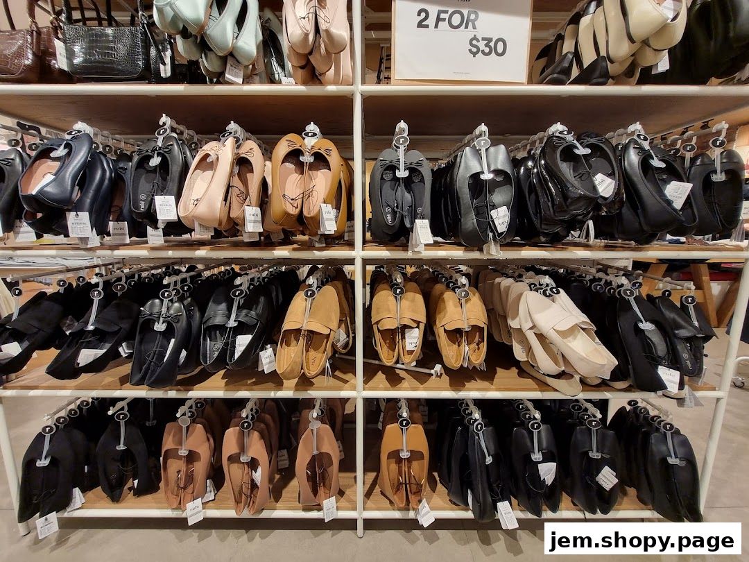 Shelves filled with various styles of women's flat shoes and handbags.