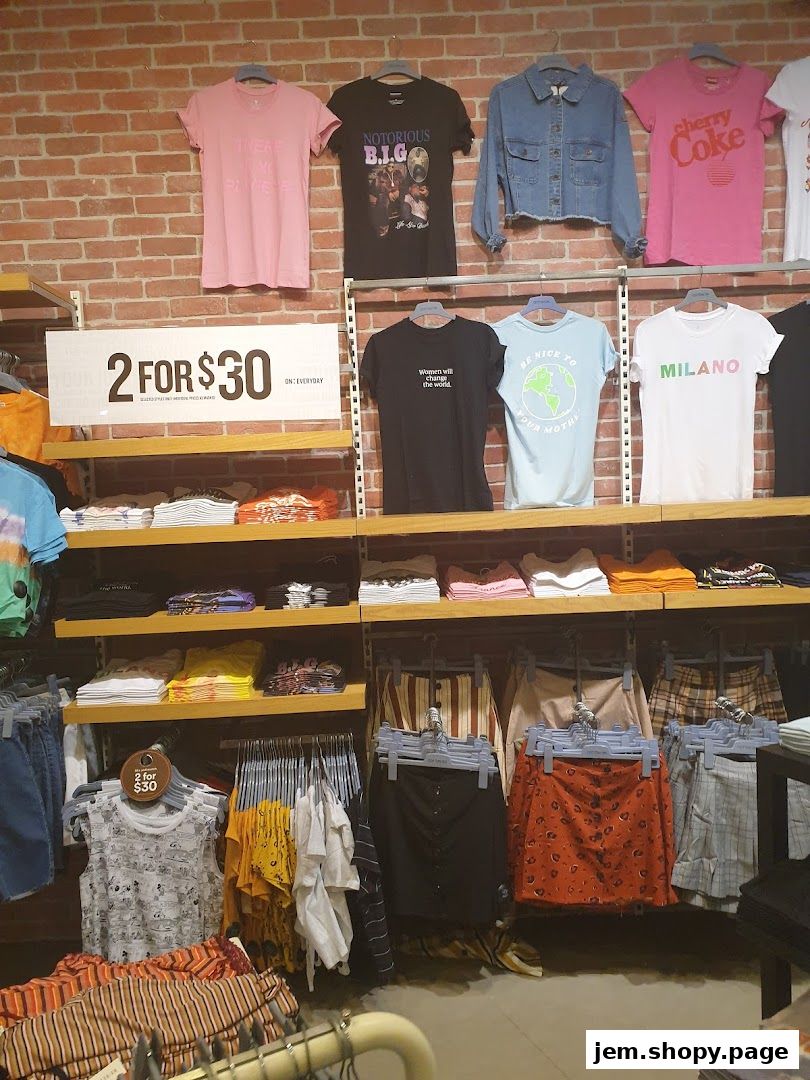 Cotton On shop interior displaying t-shirts, denim jacket, skirts, and a 2 for $30 promotion.