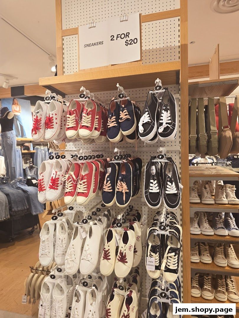 A display of various sneakers for sale, with a sign advertising '2 FOR $20'.