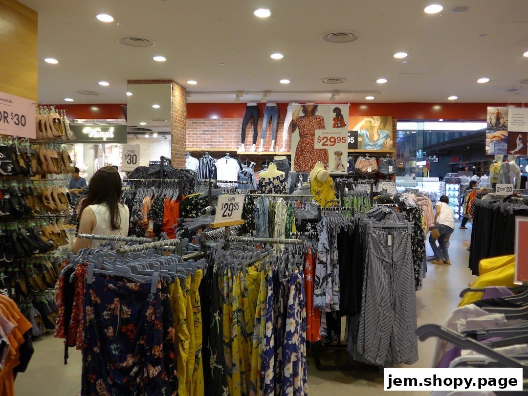 Interior view of a Cotton On store showcasing racks of colorful clothing and shoes.