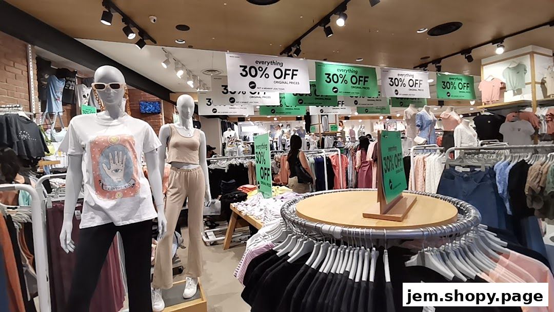 Mannequins display clothing inside a Cotton On store with '30% OFF' sale signs.