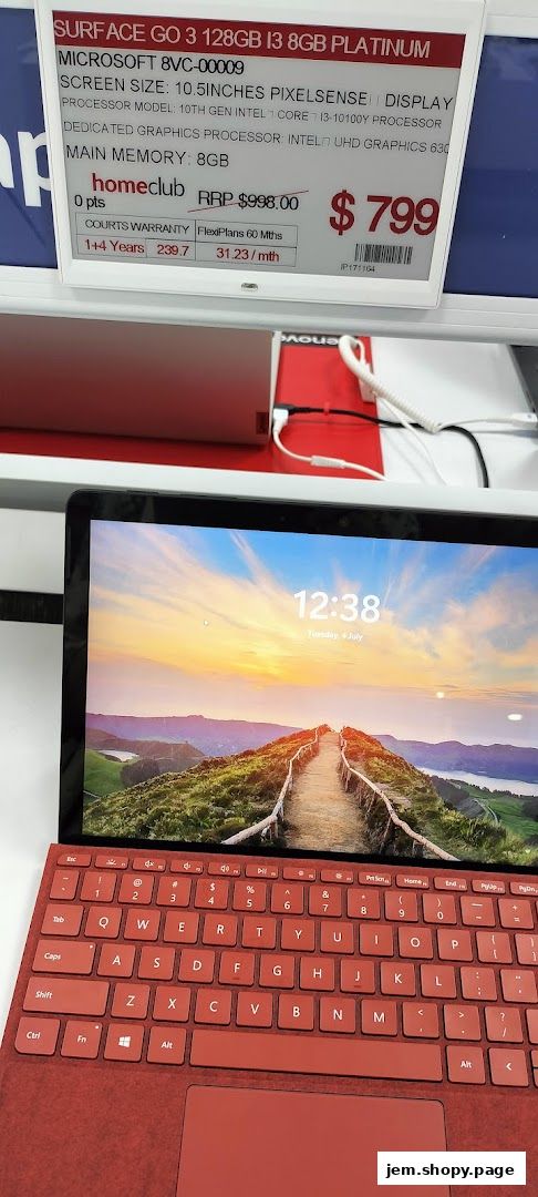 A red Microsoft Surface Go 3 laptop with a scenic wallpaper displayed on screen.