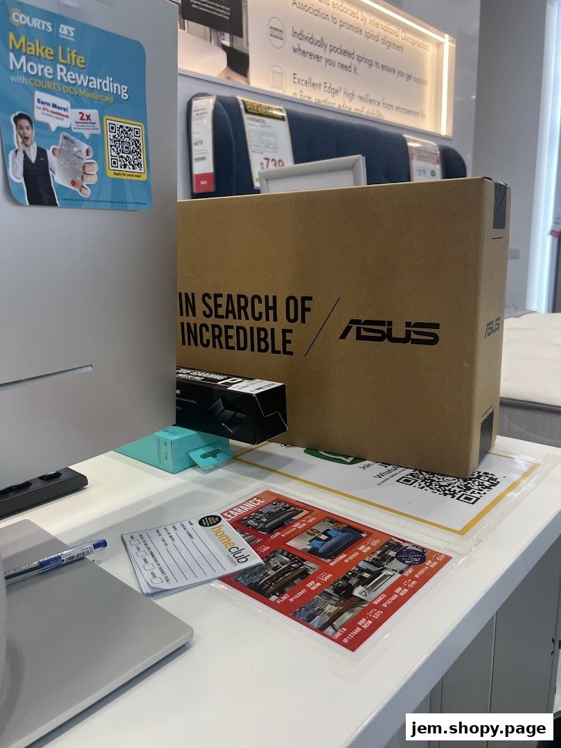 A cardboard box with 'IN SEARCH OF INCREDIBLE' and ASUS logo on a counter.