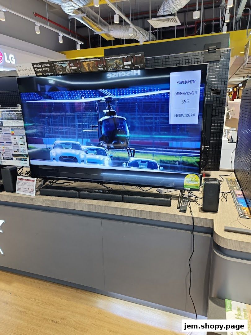 A large Sony Bravia television displaying a helicopter and cars, with soundbars and speakers.