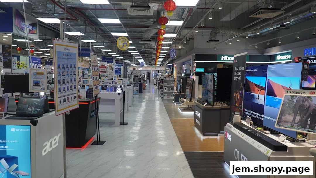 Interior view of a large electronics store, showcasing various TVs, laptops, and appliances.