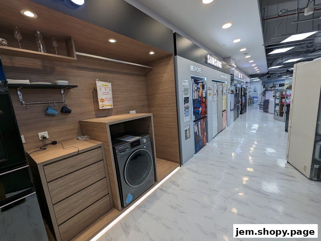 Interior view of a COURTS JEM electronics store showcasing refrigerators and a washing machine.