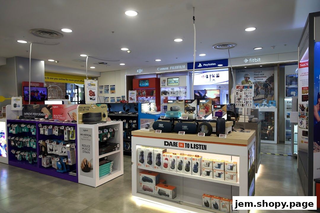 Interior view of COURTS JEM electronics store showcasing audio devices, computer accessories, and gaming consoles.