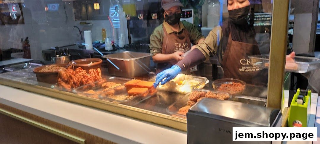 Staff preparing food behind a counter at Crave Nasi Lemak.