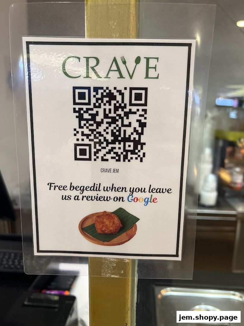 A sign from Crave Nasi Lemak JEM offering free begedil for Google reviews.