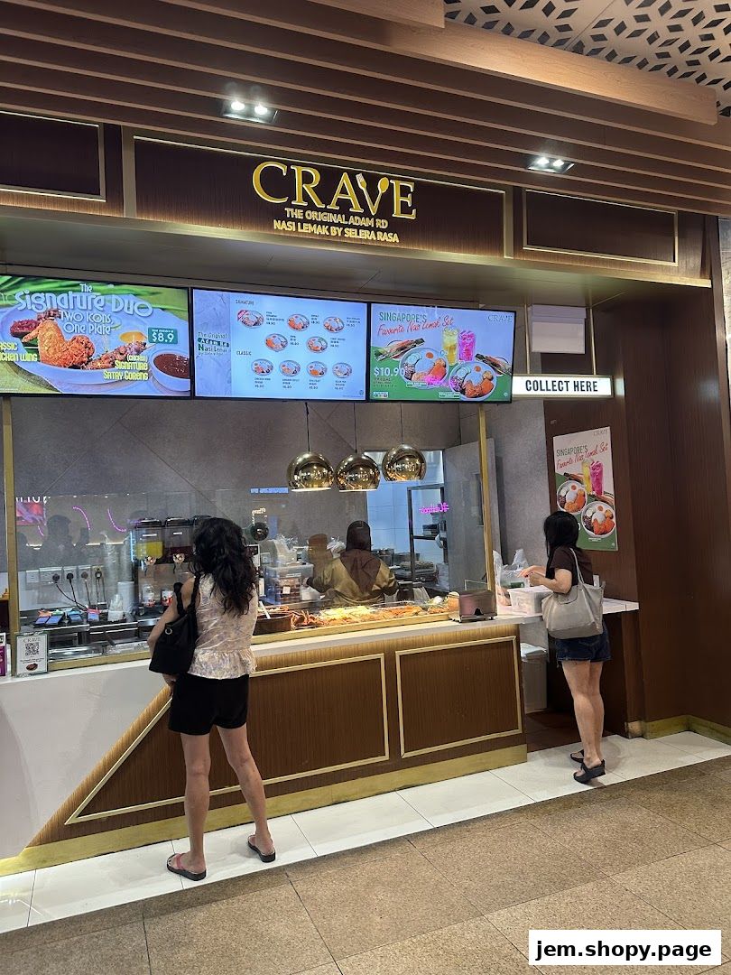 A Crave Nasi Lemak shop front with digital menus displaying food items and prices.
